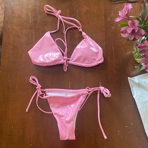 Pink bikini with a heart center on top and hearts on the bottoms. Never worn!